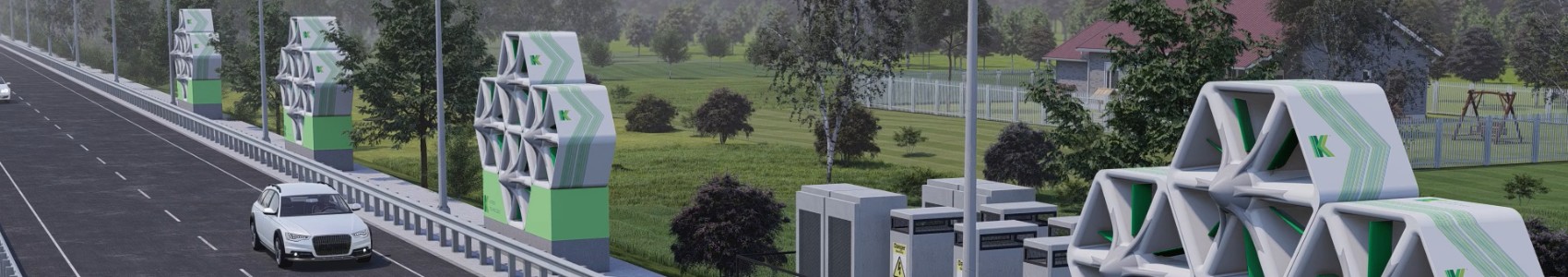 Image of green and white wind panels installed along the side of a road, designed with triangular oscillating aerofoils to generate wind energy. A white car is driving along the road, bordered by trees and green fields, with residential buildings in the background.